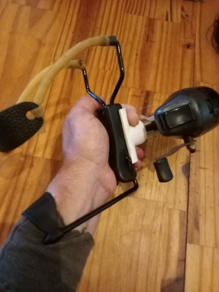 slingshot with fishing reel attached