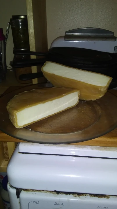 waxed cheese wheel cut in half