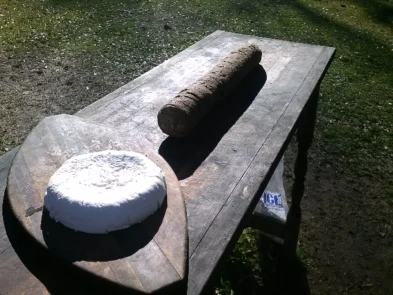 wheel of cheese on cutting board